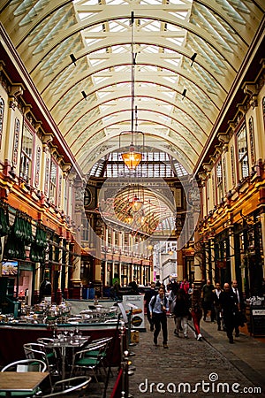 Portrait View of People Walking on an Alley Under an Arched Ceiling Editorial Stock Photo