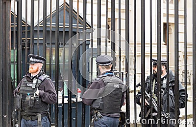 London, UK - 1st April, 2017: Police officers protecting the gate of Downing street in London, the residence of the prime Editorial Stock Photo