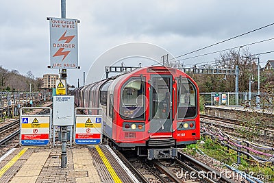 Central Line Underground train entering a station platform Editorial Stock Photo