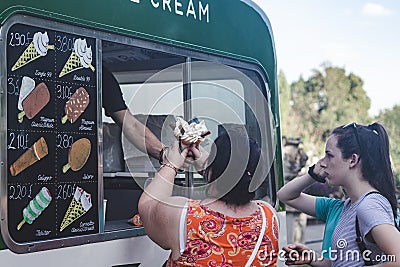 Woman buying soft serve ice cream in Ice cream van Editorial Stock Photo