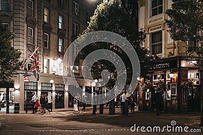 People walking past The Crown pub and shops in Seven Dials, Covent Garden, London, UK Editorial Stock Photo