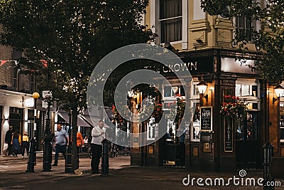 People walking past The Crown pub and shops in Seven Dials, Covent Garden, London, UK Editorial Stock Photo