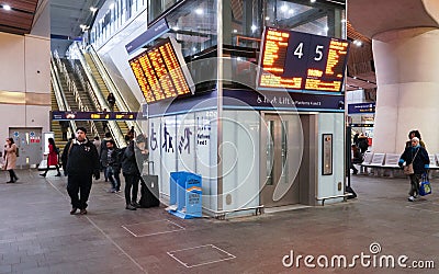 London, United Kingdom - February 01, 2019: Passengers walking under departure boards and lift at London Bridge station. It is Editorial Stock Photo