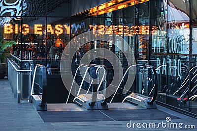 London, United Kingdom - February 03, 2019: Yellow neon letters sign on Big Easy restaurant window at their Canary Wharf branch. Editorial Stock Photo