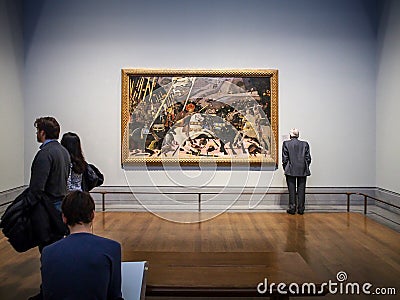 London, The United Kingdom - Visitors looking at paintings in the National Gallery. Editorial Stock Photo