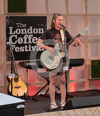 LONDON, UNITED KINGDOM - Mar 30, 2019: A performer singing and playing the guitar Editorial Stock Photo