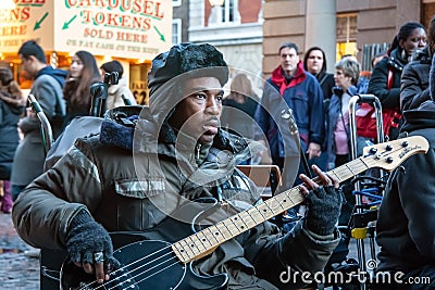 London, United Kingdom - November 25th, 2006: Unknown busker plays bass guitar and signs at Covent Garden. Street performers are Editorial Stock Photo