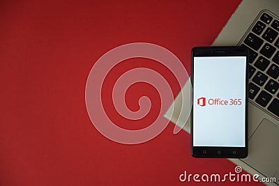 Microsoft Office 365 logo on smartphone screen placed on laptop keyboard. Editorial Stock Photo