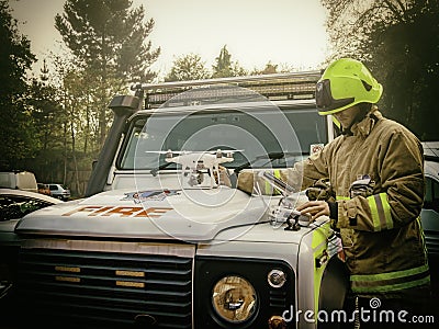 Engineer tuning some drones next to a fire vehicle Editorial Stock Photo