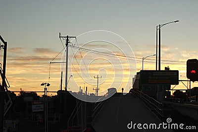 Lone bicycle cyclist riding across a city bridge on a summer day after work riding into the sunset, Melbourne city, Victoria, Stock Photo