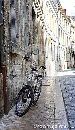 Lone bicycle on Bordeaux side street Stock Photo