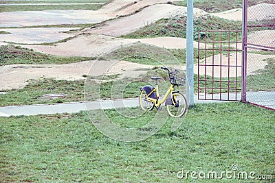 Lone bicycle parked by a pillar near a mountain ride Stock Photo