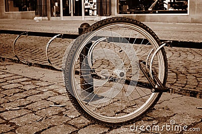 A lone bicycle wheel in a street Stock Photo