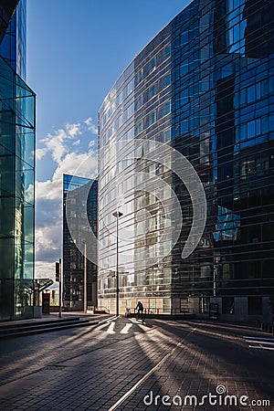 A lone bicyclist at sunset in the Paris business district of La Defense Editorial Stock Photo