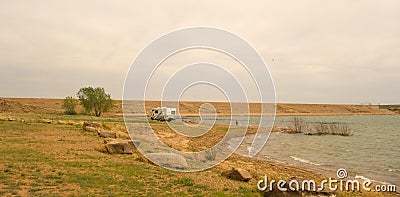 A lone camper at ute state park dam, new mexico Editorial Stock Photo