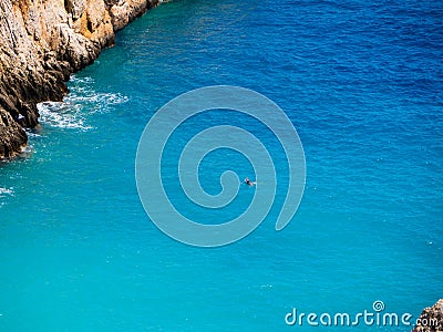 Lone diver in a amazing blue cove - crystal blue sea Stock Photo