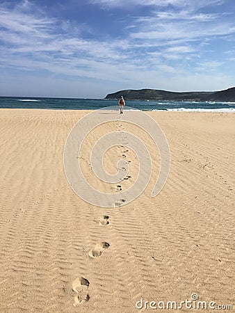 Lone hiker on beach Stock Photo