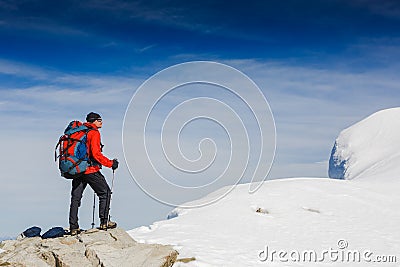 Lone hiker in winter mountains Stock Photo