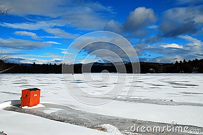 A lone ice fishing shack stands on a frozen lake Editorial Stock Photo