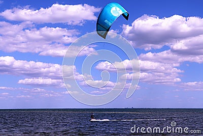 Lone kite surfer with beautiful blue skies and parting clouds Editorial Stock Photo