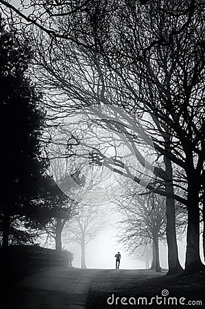 Lone Runner on a Misty Morning Stock Photo