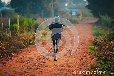 A lone runner trains in Kenya. A marathon runner runs on red soil in the city of Iten, home of Champions. Motivation to run, Editorial Stock Photo