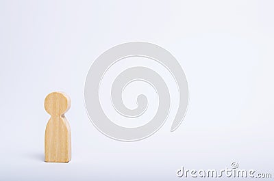 A lone wooden human figure stands on a white background. A person is waiting, standing and waiting. Style of minimalism, space Stock Photo