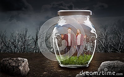 Loneliness concept, couple in big cracked jar Stock Photo