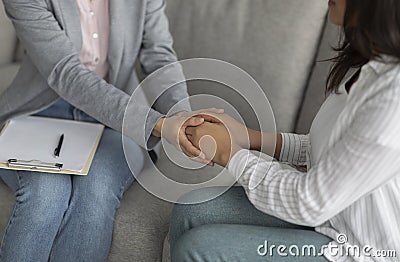 Loneliness, despair and depression concept. Professional psychologist touching female patient hands Stock Photo