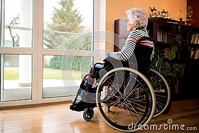 Loneliness senior woman sitting in wheelchair at nursing home Stock Photo