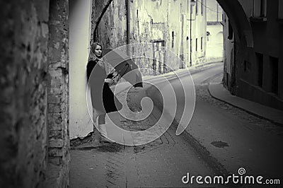 Lonelly woman with umbrella in a street, retro Stock Photo