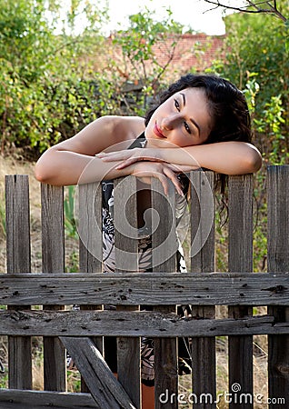 Lonely against a fence Stock Photo