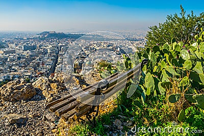 a lonely bench provides an aerial view of athens at the top of lycabetus hill...IMAGE Editorial Stock Photo