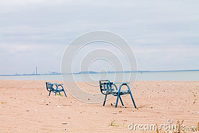 Lonely benches in an abandoned village in the area of hostilities in Ukraine. View from the Sea of Azov to Mariupol. Smoking Stock Photo