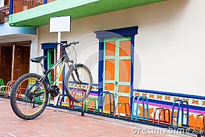 Lonely bicycle parked on a colorful rack at the beautiful Guatape Editorial Stock Photo