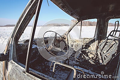 Lonely burnt car on a suburban highway Stock Photo