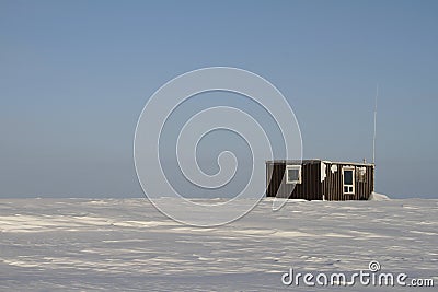 Lonely cabin in a snow landscape on the arctic tundra Stock Photo