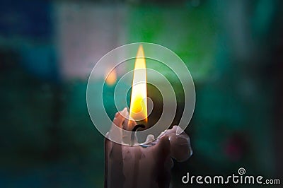 Lonely candle on a blurred background Stock Photo