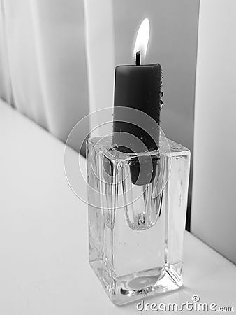 a lonely candle is burning Stock Photo