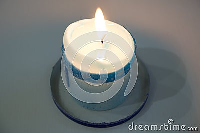 Lonely candle in a candlestick Stock Photo