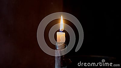 Lonely candle on a dark background Stock Photo