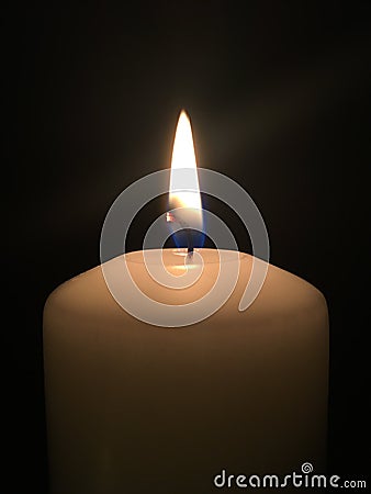 Lonely candle in the dark Stock Photo