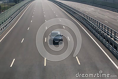 lonely car driving on a multi-lane highway Stock Photo