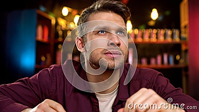 Lonely caucasian man spending time watching news on tv in bar, evening leisure Stock Photo