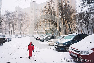 Lonely child walking in snow Stock Photo