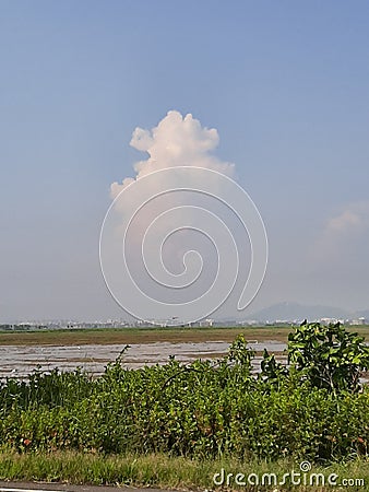 A lonely cloud in the sky. A bright sunny day. Stock Photo