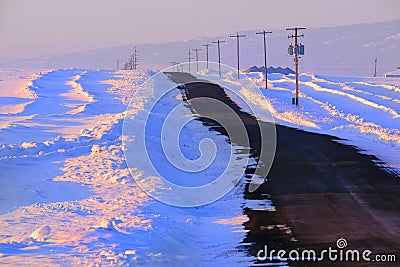 Lonely Country Road in the Winter with Powerlines Stock Photo