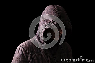 Lonely, depressed and fragile Caucasian or white man hiding face, standing in the darkness Stock Photo