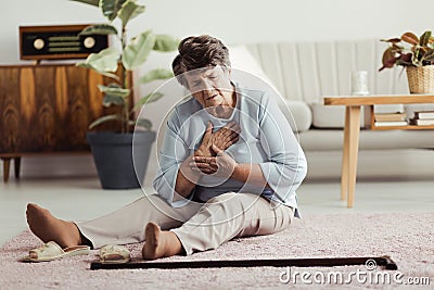 Elderly woman having heart attack Stock Photo