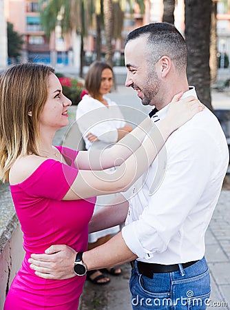 Lonely female is envying to smiling couple Stock Photo